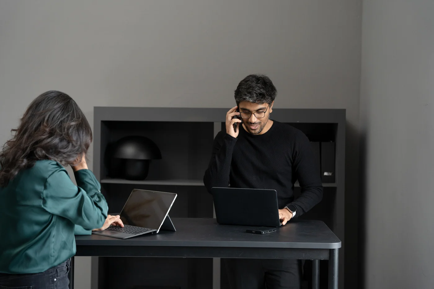 Two people discussing a computer setup